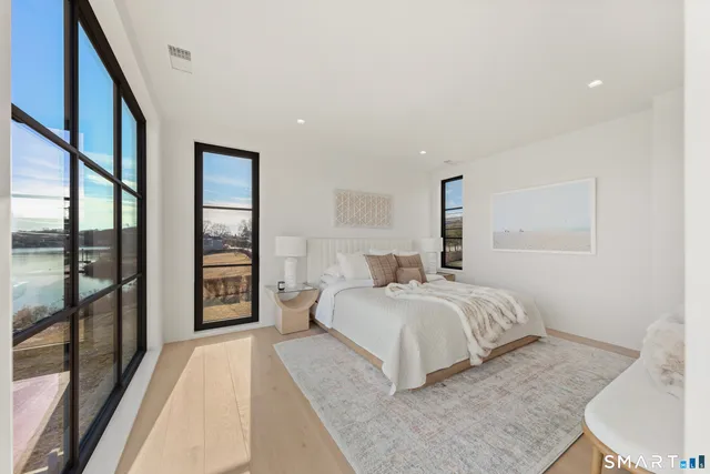 a bedroom with a large bed and a large window