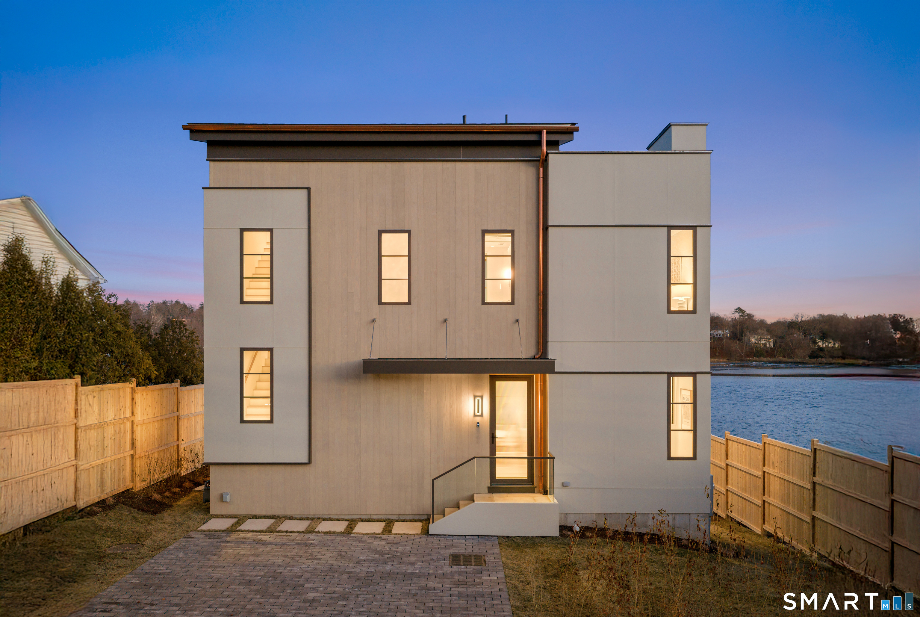 79 Riverside Avenue Westport, CT 06880 - Photo 22 of 40 a front view of a house with lake view and outdoor space