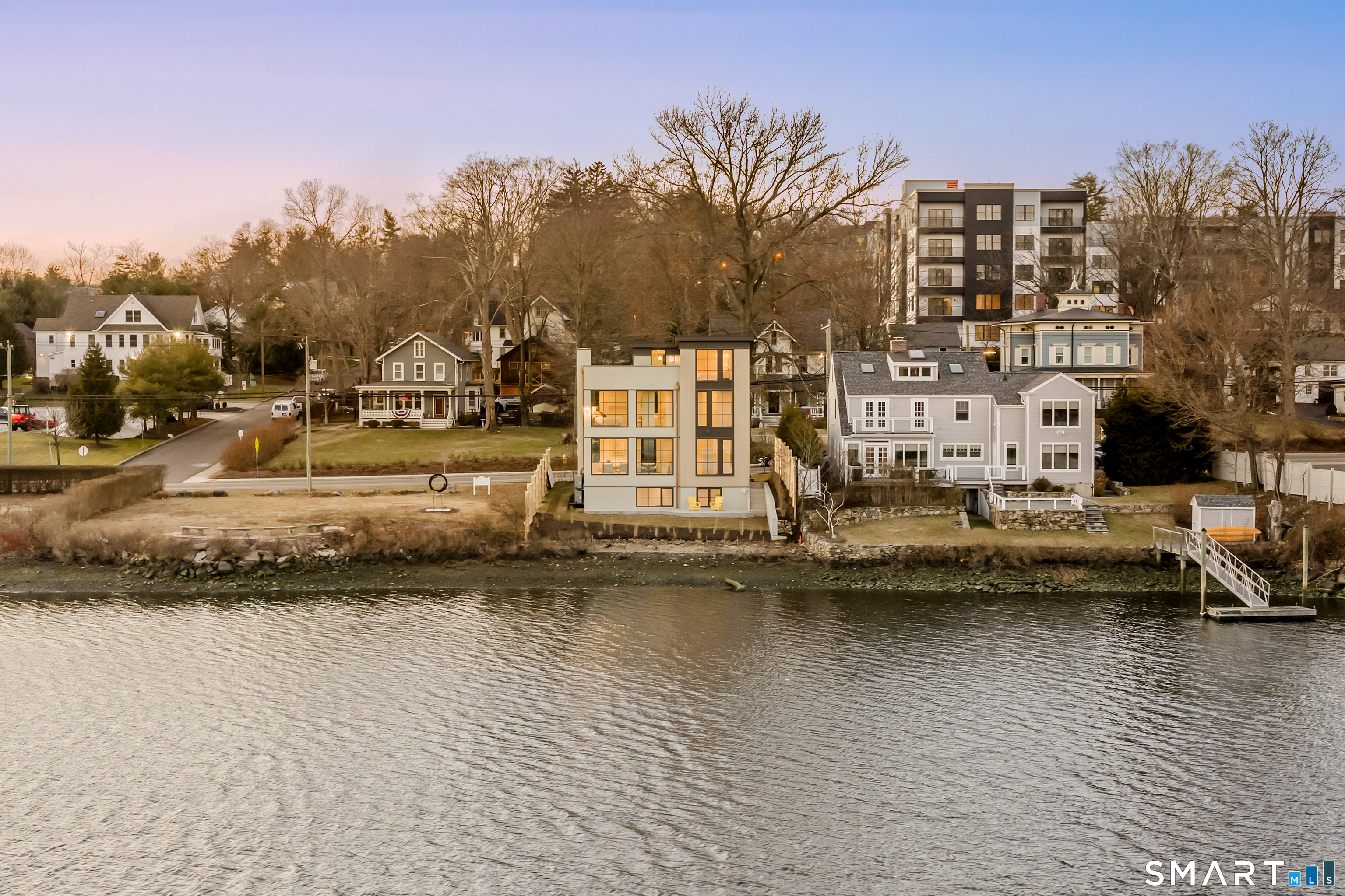 79 Riverside Avenue Westport, CT 06880 - Photo 23 of 40 a view of a ocean with boats and trees in the background