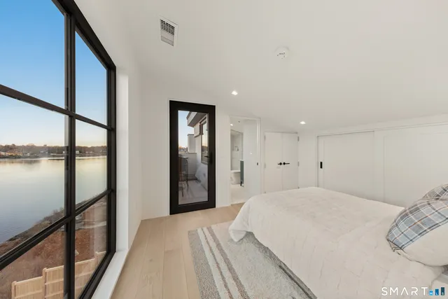 a view of a bedroom with a large bed and large window