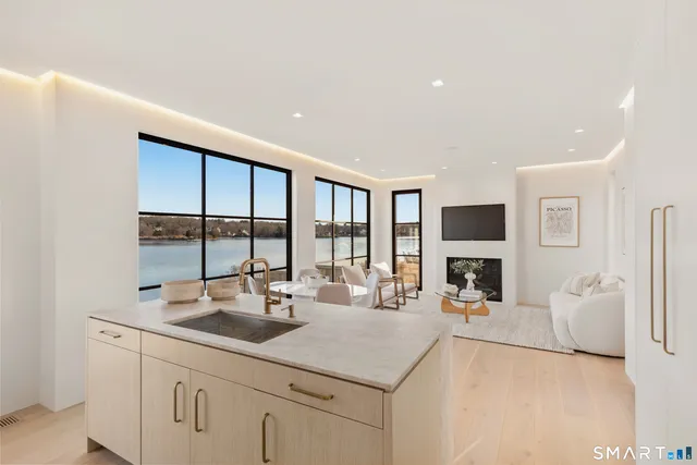 a kitchen with sink refrigerator and fireplace