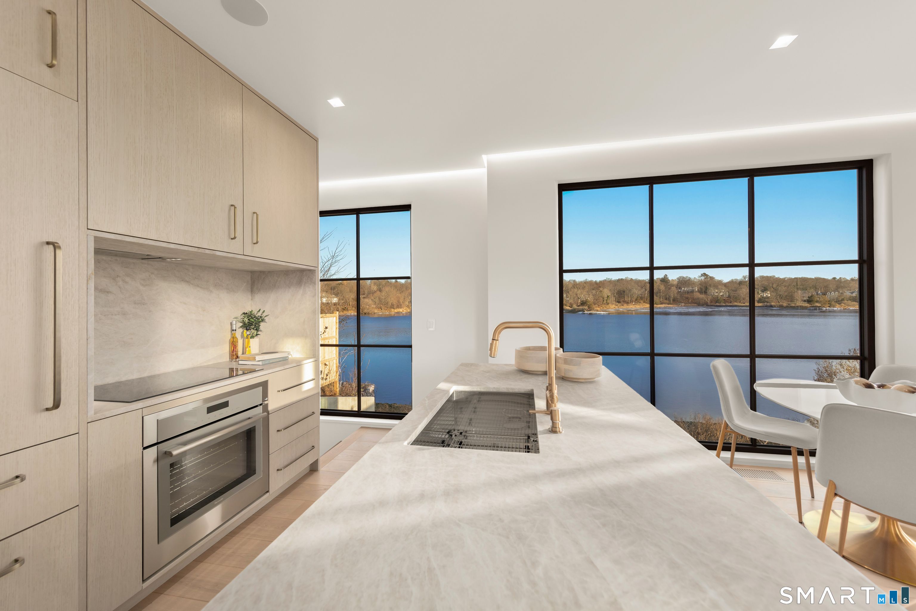 79 Riverside Avenue Westport, CT 06880 - Photo 6 of 40 a kitchen with granite countertop a stove and white cabinets