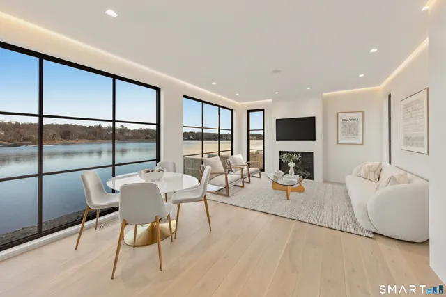 a living room with fireplace furniture and a floor to ceiling window