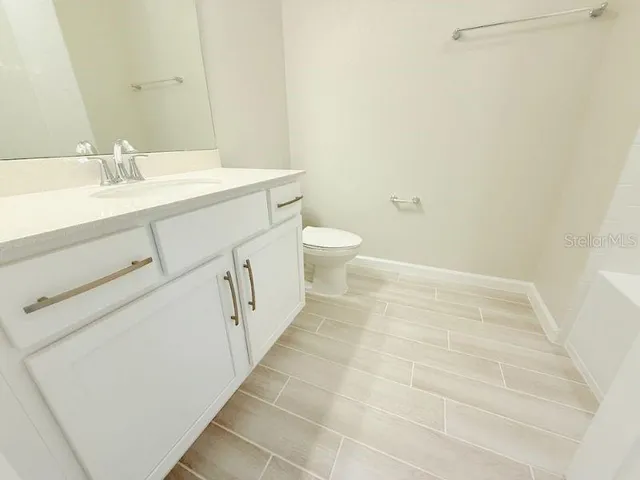 a view of a big room with staircase and door