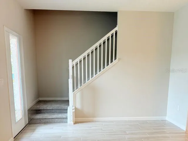 a large kitchen with kitchen island a sink a stove a refrigerator and white cabinets