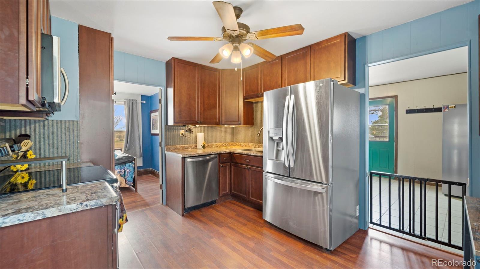 1935 County Road 75 Fleming, CO 80728 - Photo 14 of 50 a kitchen with stainless steel appliances granite countertop a refrigerator and a sink