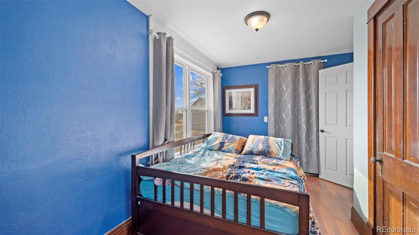 1935 County Road 75 Fleming, CO 80728 - Photo 16 of 50 a bedroom with a bed and a window