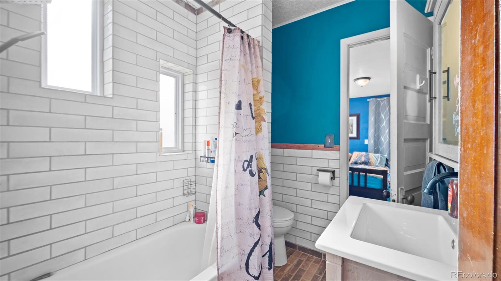 1935 County Road 75 Fleming, CO 80728 - Photo 10 of 50 a bathroom with a bathtub and shower