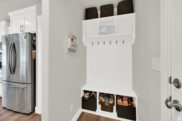 2777 West 4175th Street South, Unit 232 Roy, UT 84067 - Photo 13 of 27 Built-in hall tree with upper shelving, coat hooks, and lower cubbies, complemented by LVP flooring