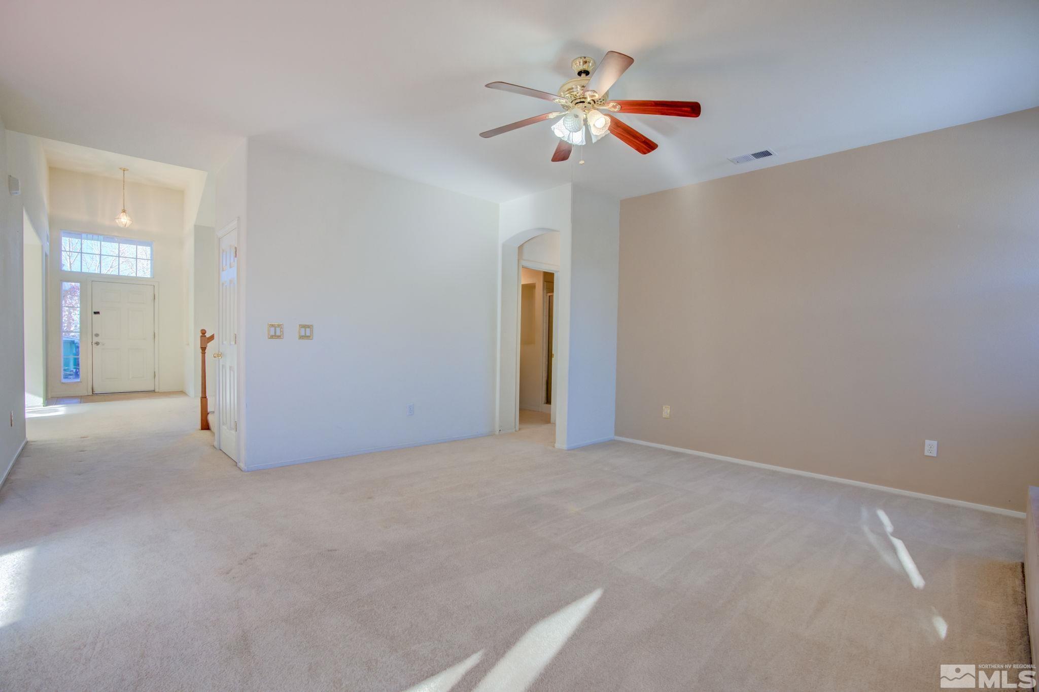 10692 Copper Moon Court Reno, NV 89521 - Photo 11 of 40 a view of an empty room with a chandelier fan