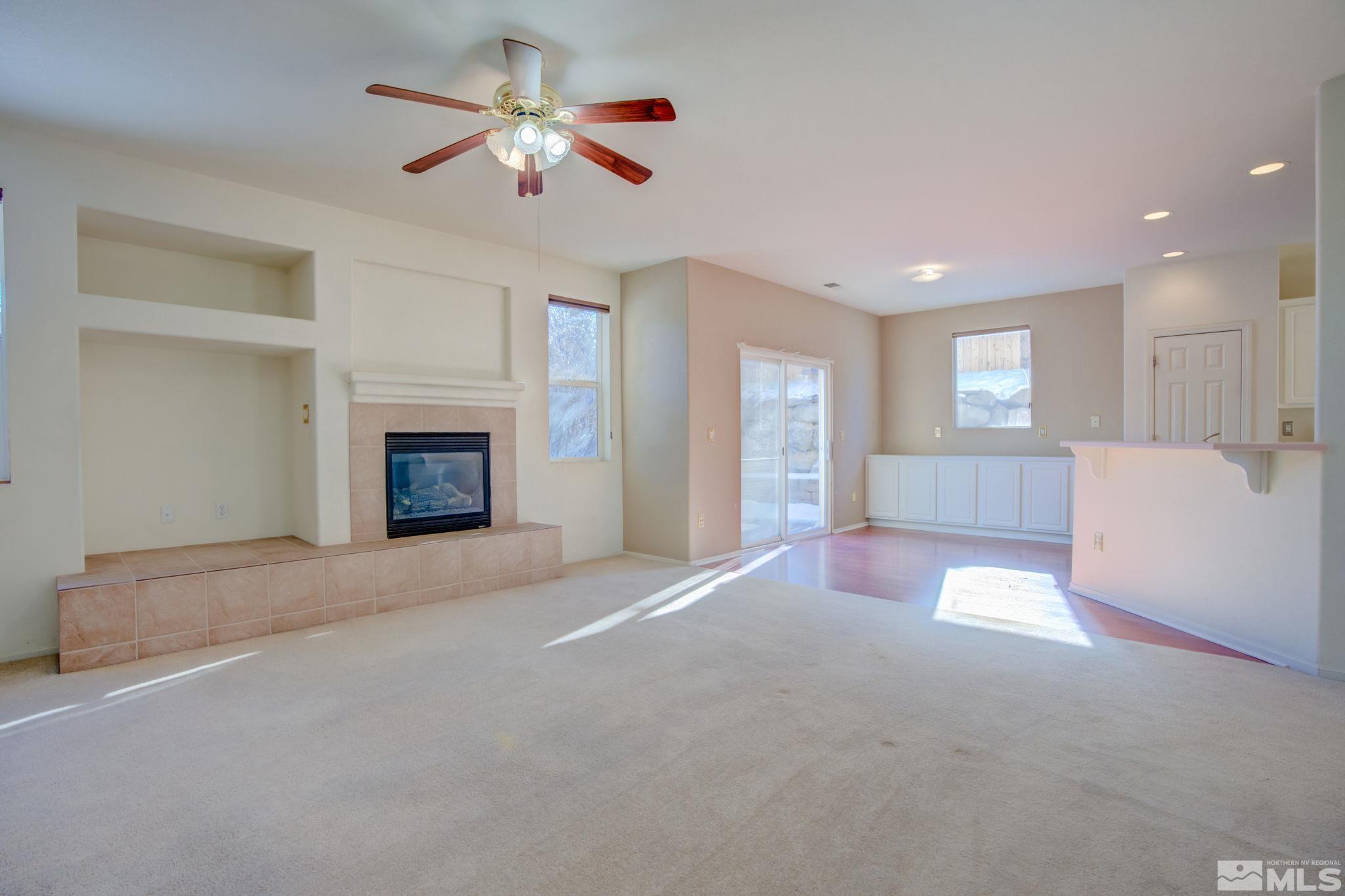 10692 Copper Moon Court Reno, NV 89521 - Photo 12 of 40 a view of an empty room with a fireplace and a window