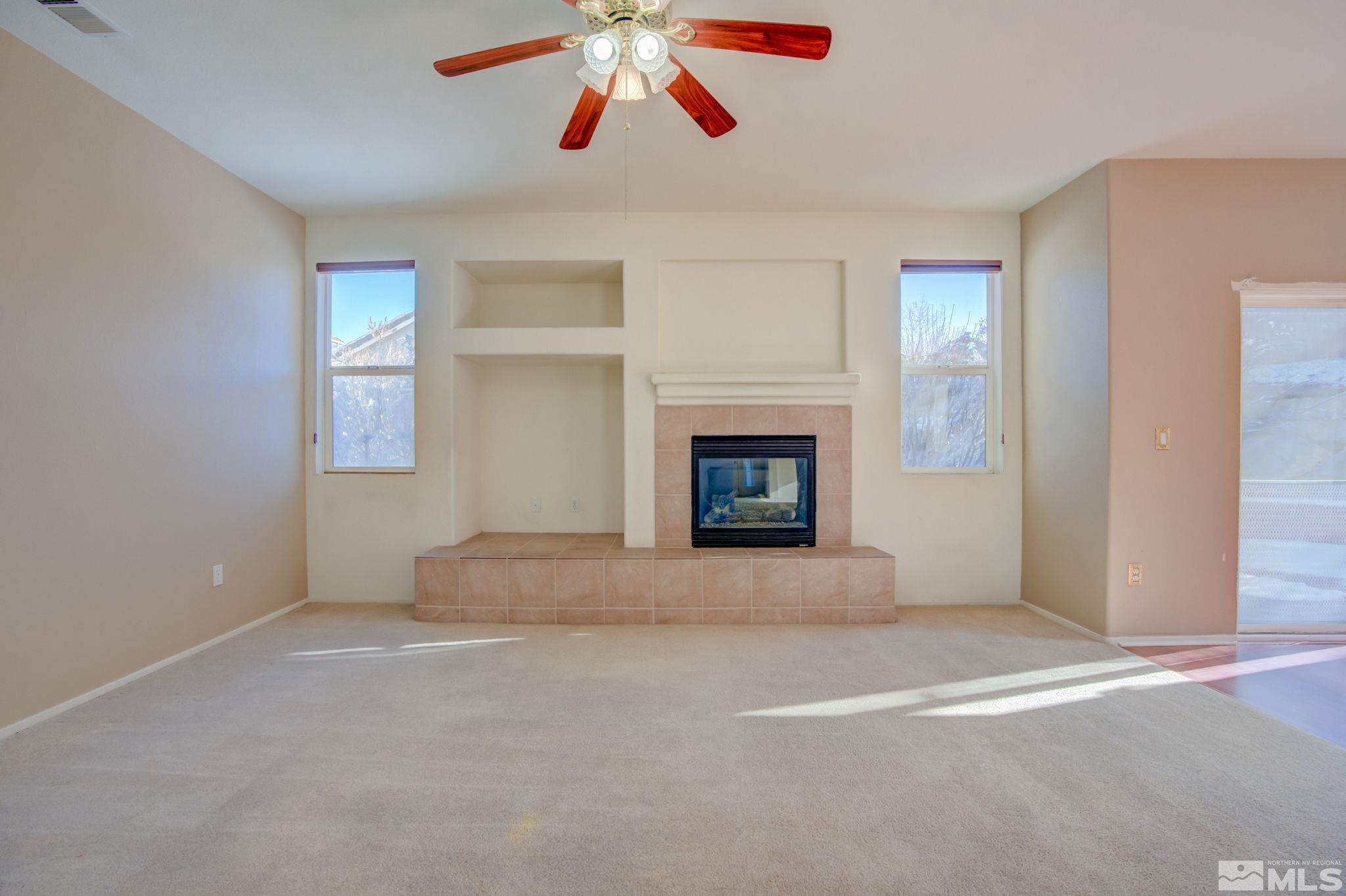 10692 Copper Moon Court Reno, NV 89521 - Photo 13 of 40 an empty room with windows and fireplace