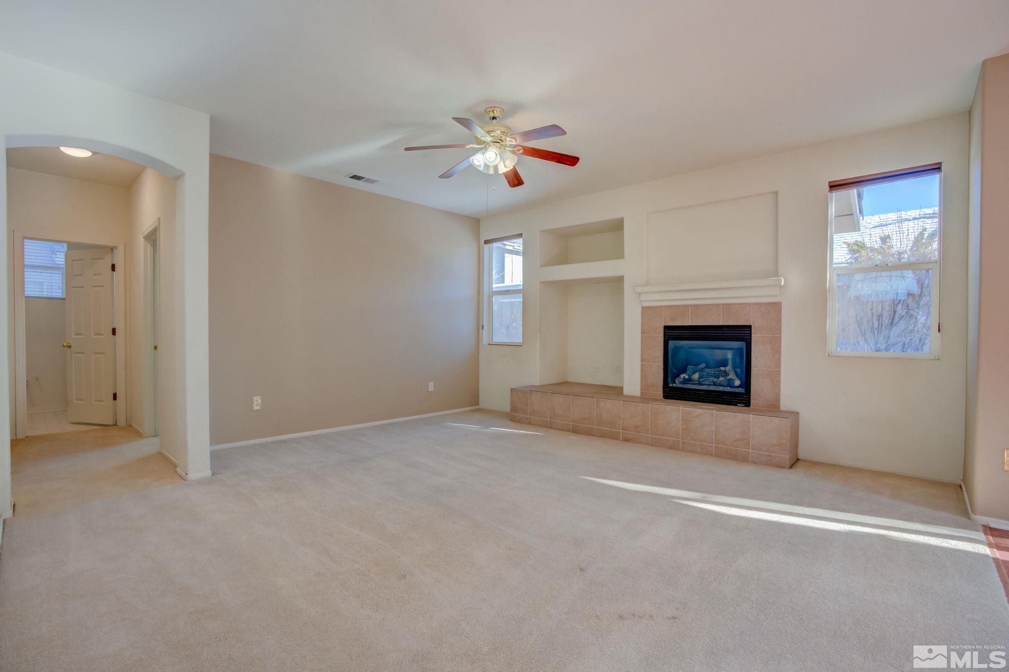10692 Copper Moon Court Reno, NV 89521 - Photo 14 of 40 an empty room with windows and fireplace