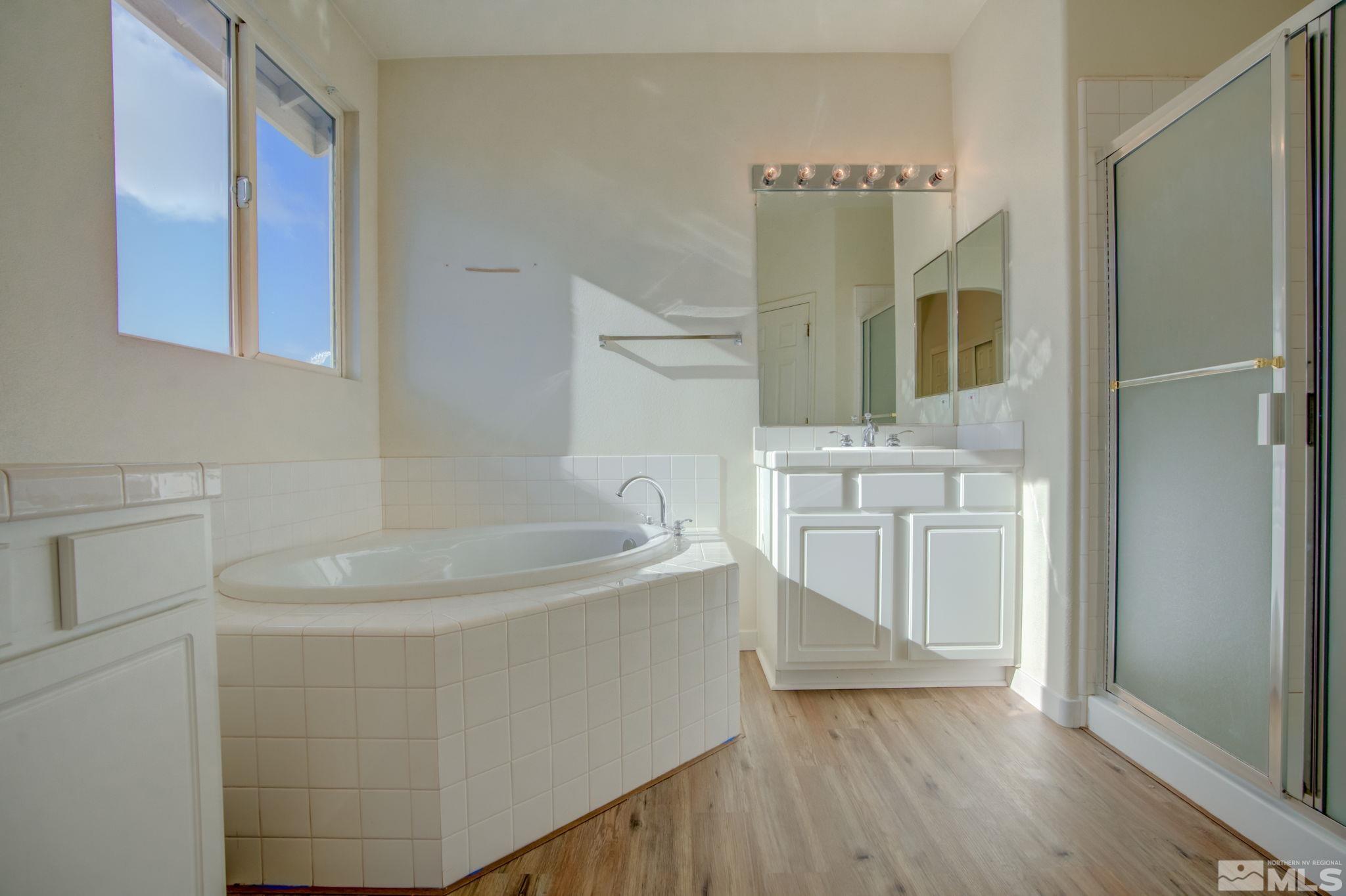 10692 Copper Moon Court Reno, NV 89521 - Photo 29 of 40 a bathroom with a bathtub and a sink