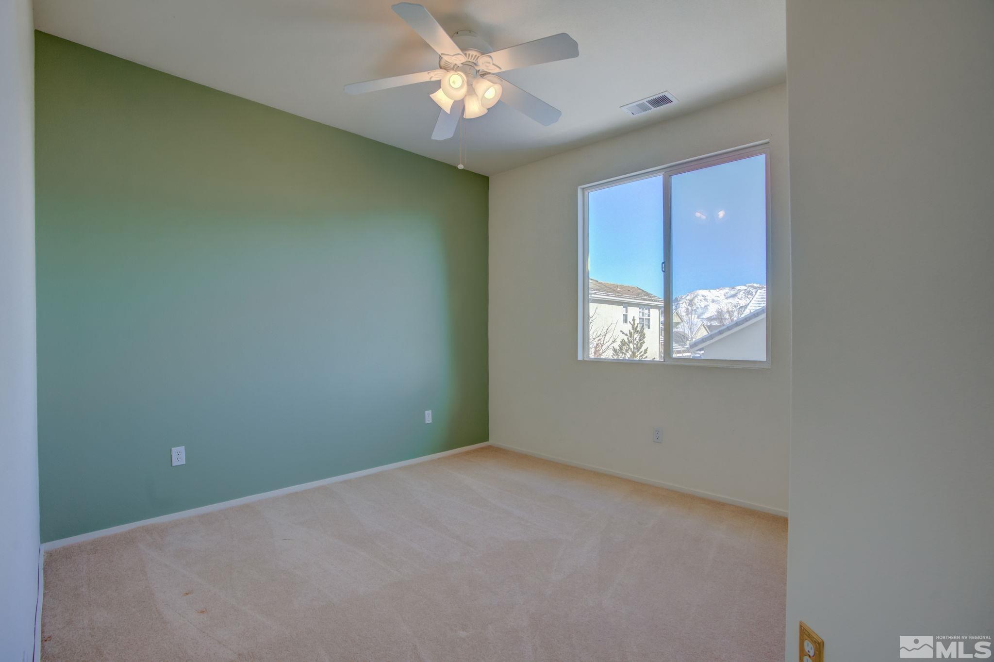 10692 Copper Moon Court Reno, NV 89521 - Photo 32 of 40 an empty room with a window and a fan