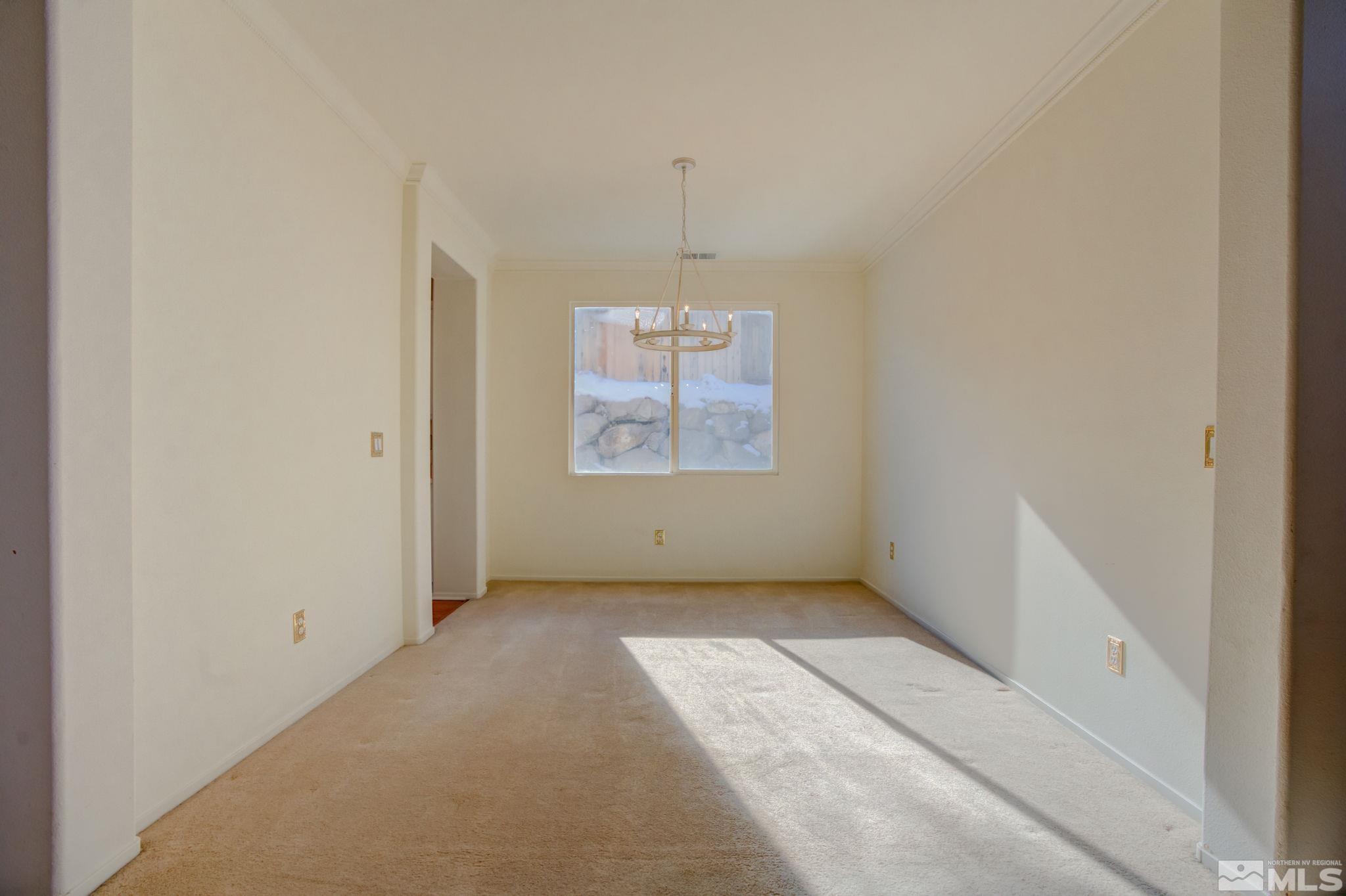 10692 Copper Moon Court Reno, NV 89521 - Photo 9 of 40 an empty room with windows and fireplace