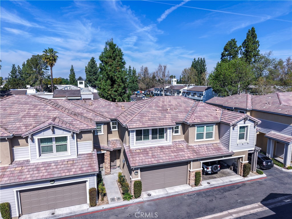 7863 Marbil Lane Riverside, CA 92504 - Photo 1 of 30 a front view of a house with a garden and trees