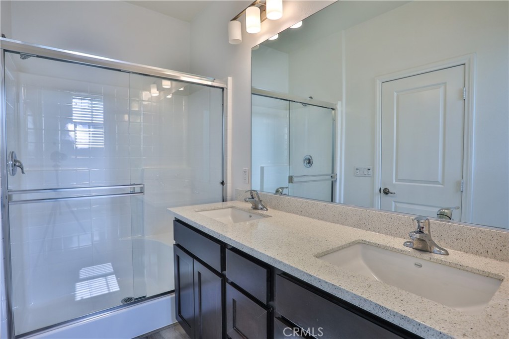 7863 Marbil Lane Riverside, CA 92504 - Photo 17 of 30 a bathroom with a sink double vanity and a mirror