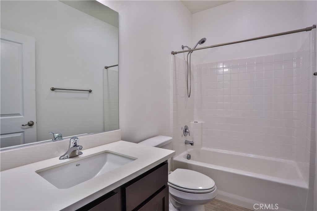 7863 Marbil Lane Riverside, CA 92504 - Photo 25 of 30 a bathroom with a sink toilet and shower