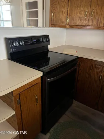 a close view of a stove a microwave and cabinets