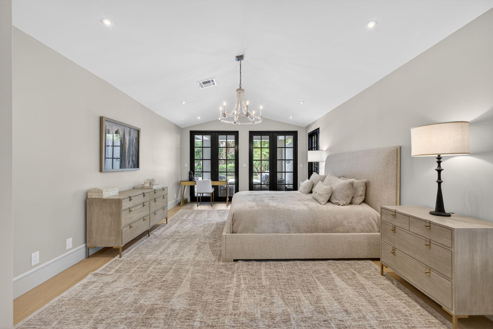 17 Carrick Road Palm Beach Gardens, FL 33418 - Photo 20 of 53 a spacious bedroom with a large bed and a chandelier
