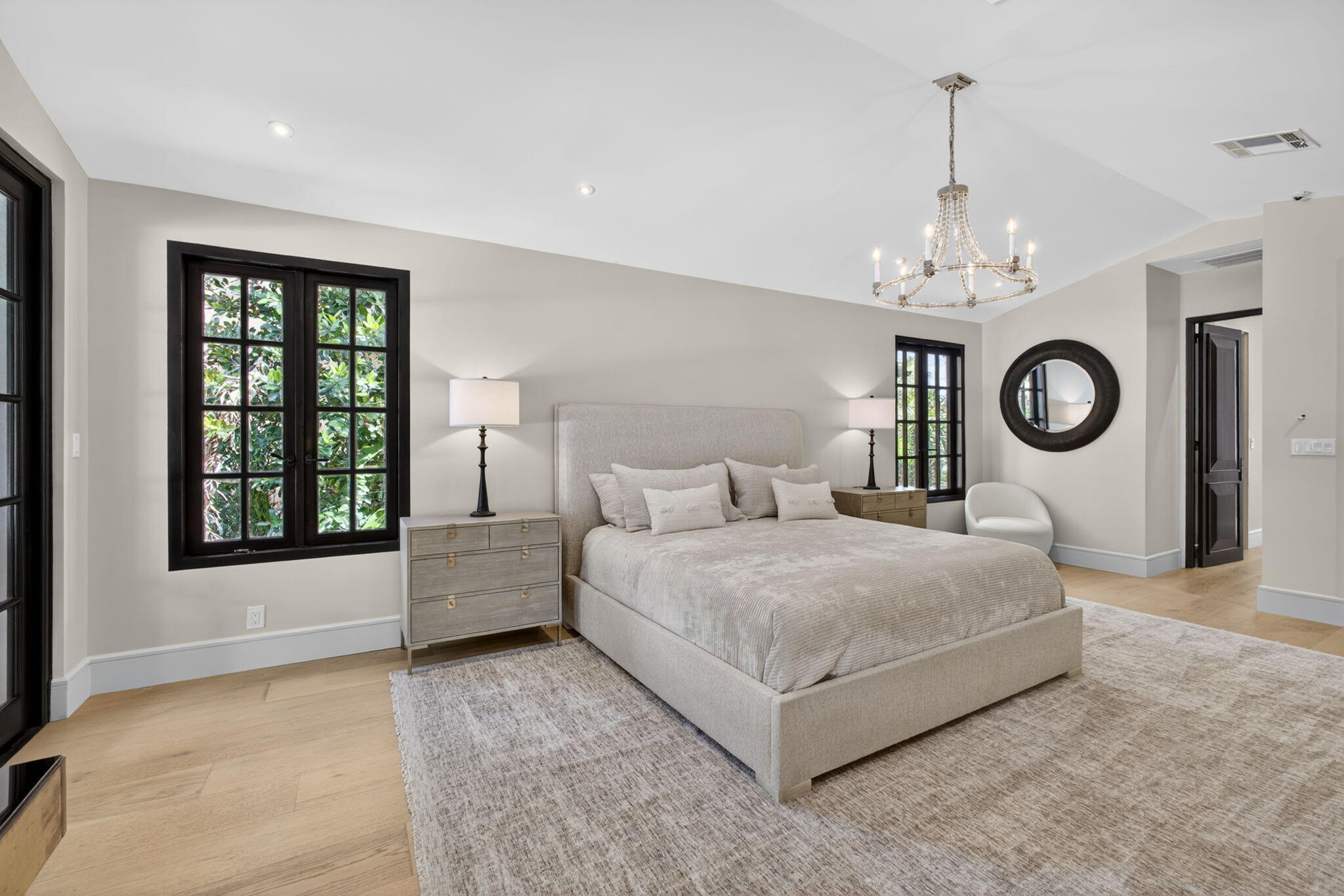 17 Carrick Road Palm Beach Gardens, FL 33418 - Photo 22 of 53 a bedroom with a large bed and a chandelier