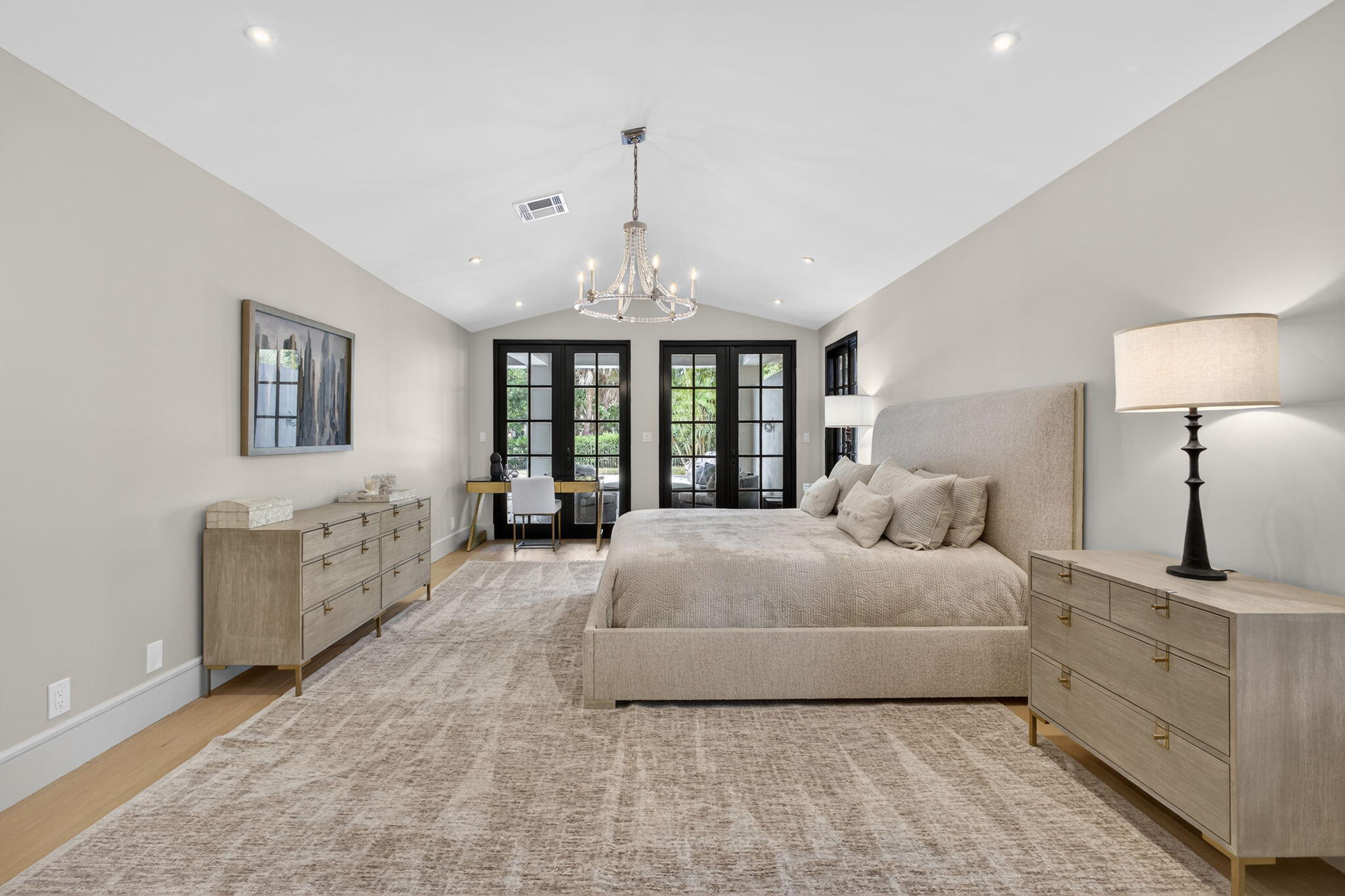 17 Carrick Road Palm Beach Gardens, FL 33418 - Photo 22 of 54 a spacious bedroom with a large bed and a chandelier