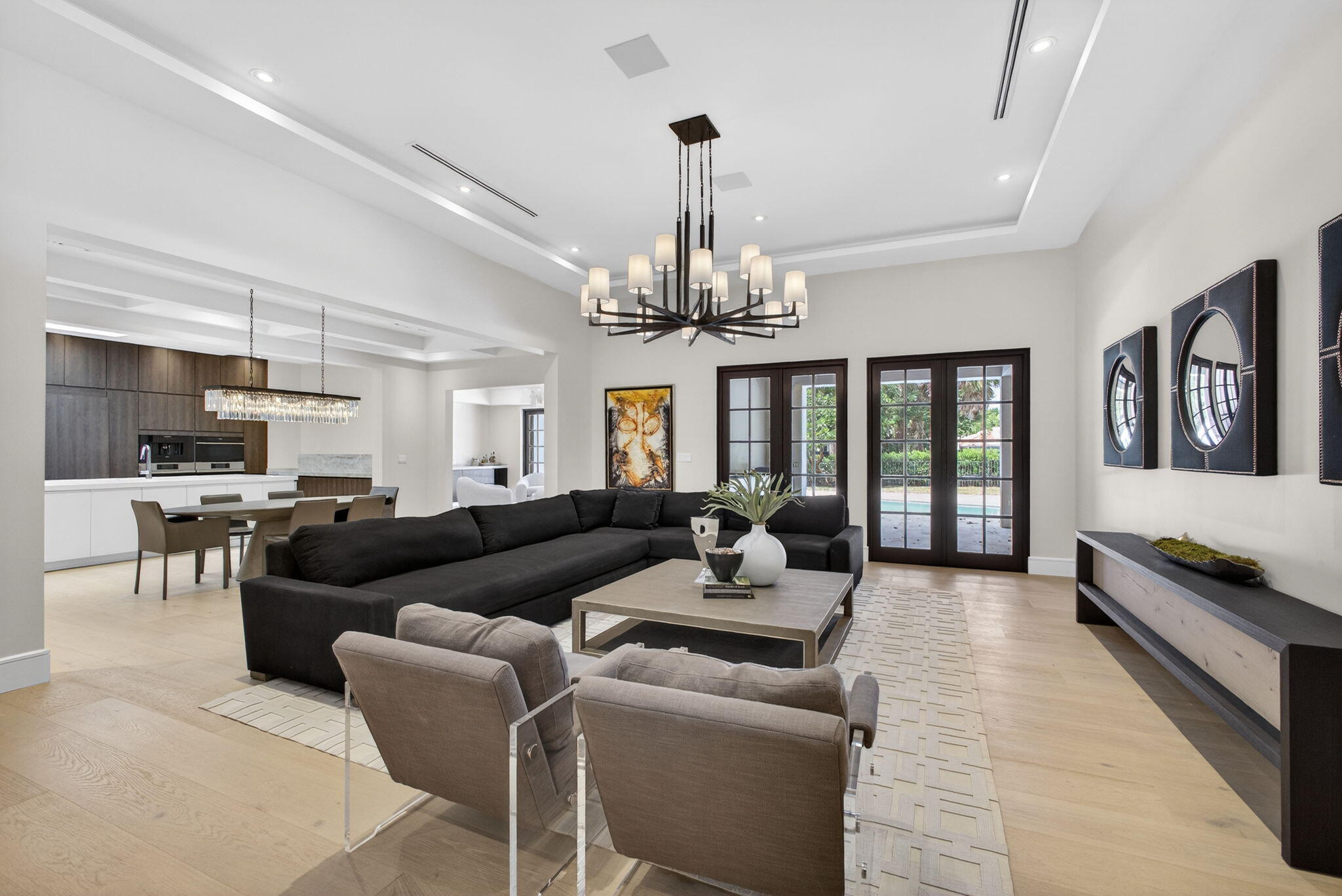 17 Carrick Road Palm Beach Gardens, FL 33418 - Photo 3 of 54 a living room with furniture and a chandelier