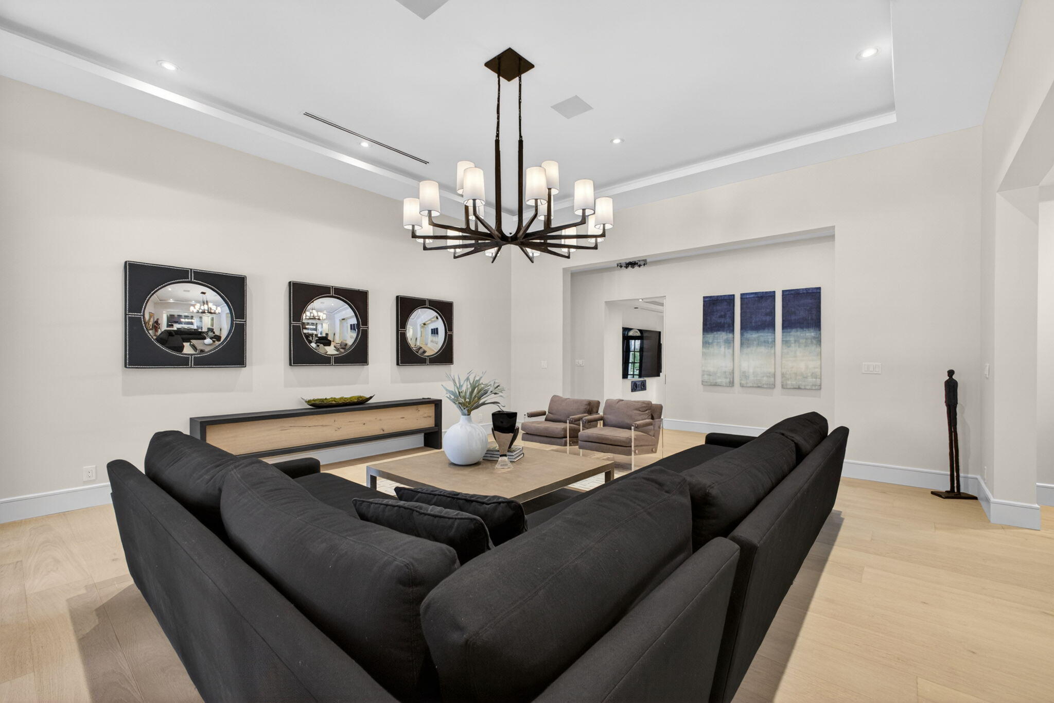 17 Carrick Road Palm Beach Gardens, FL 33418 - Photo 4 of 53 a living room with furniture a chandelier and a flat screen tv