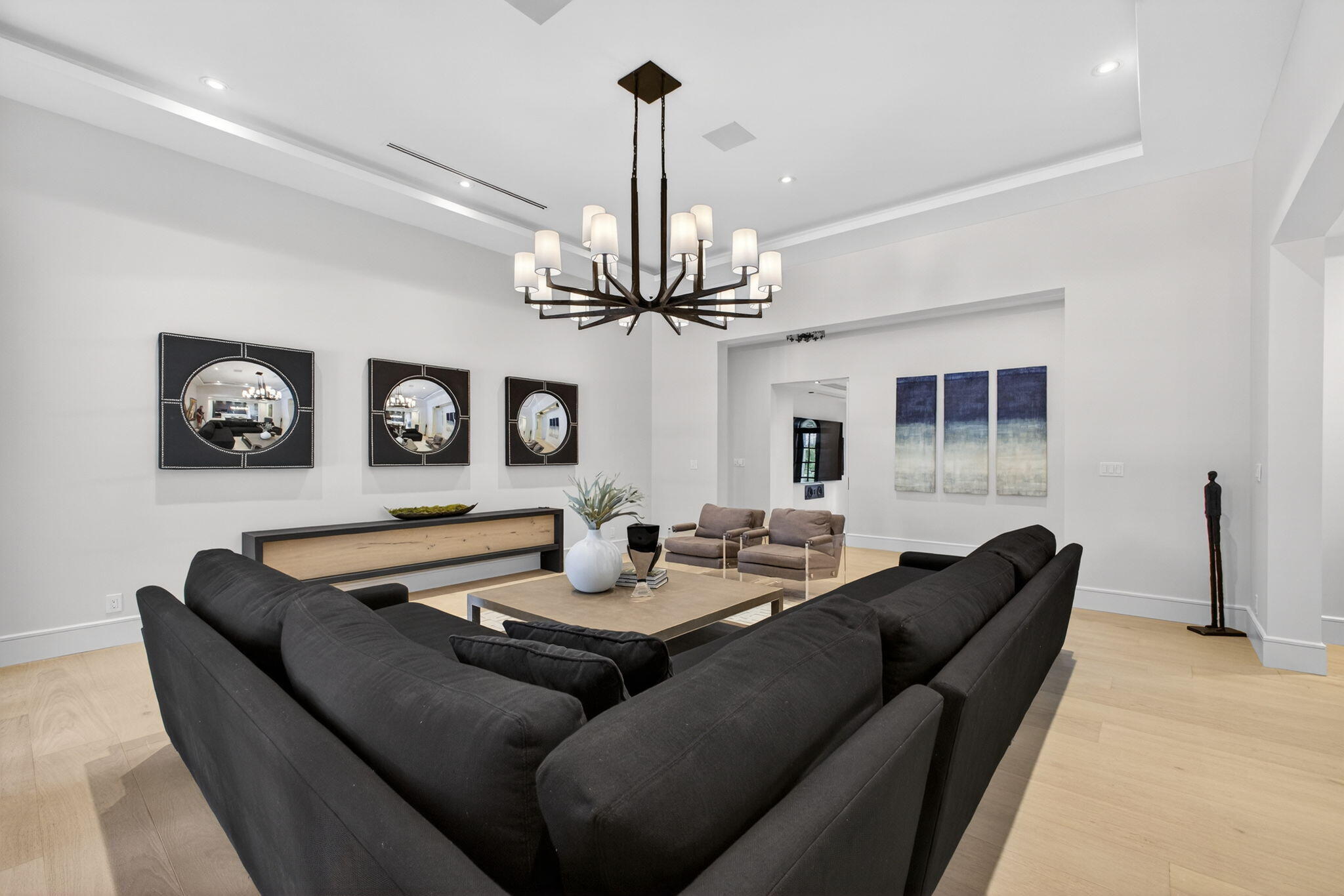 17 Carrick Road Palm Beach Gardens, FL 33418 - Photo 4 of 54 a living room with furniture a chandelier and a flat screen tv