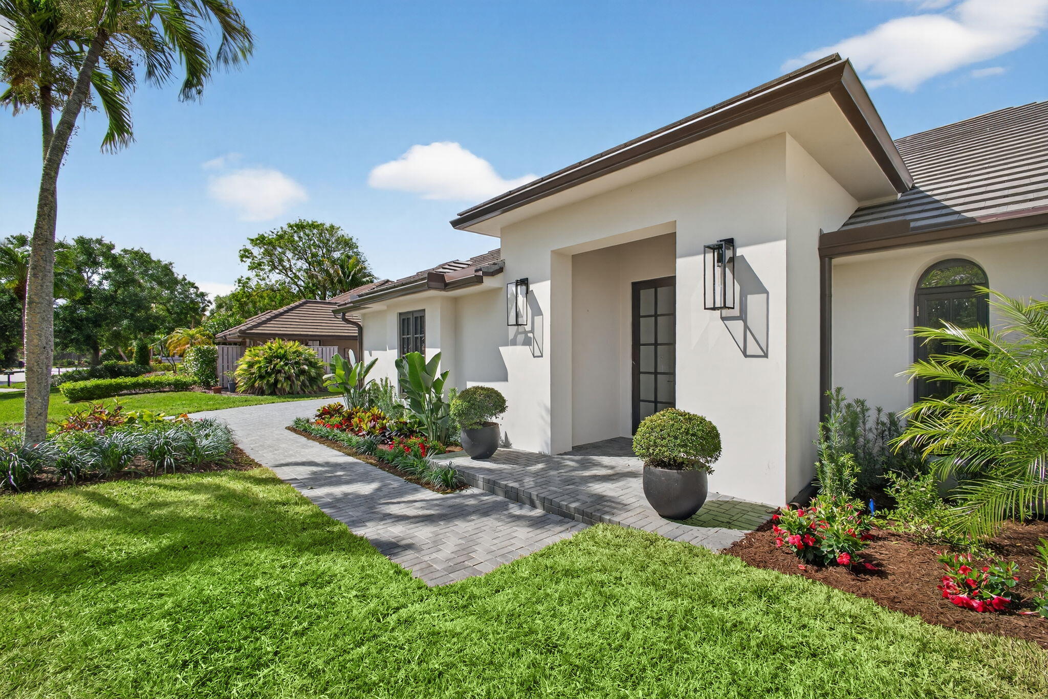 17 Carrick Road Palm Beach Gardens, FL 33418 - Photo 44 of 54 a front view of a house with porch and garden