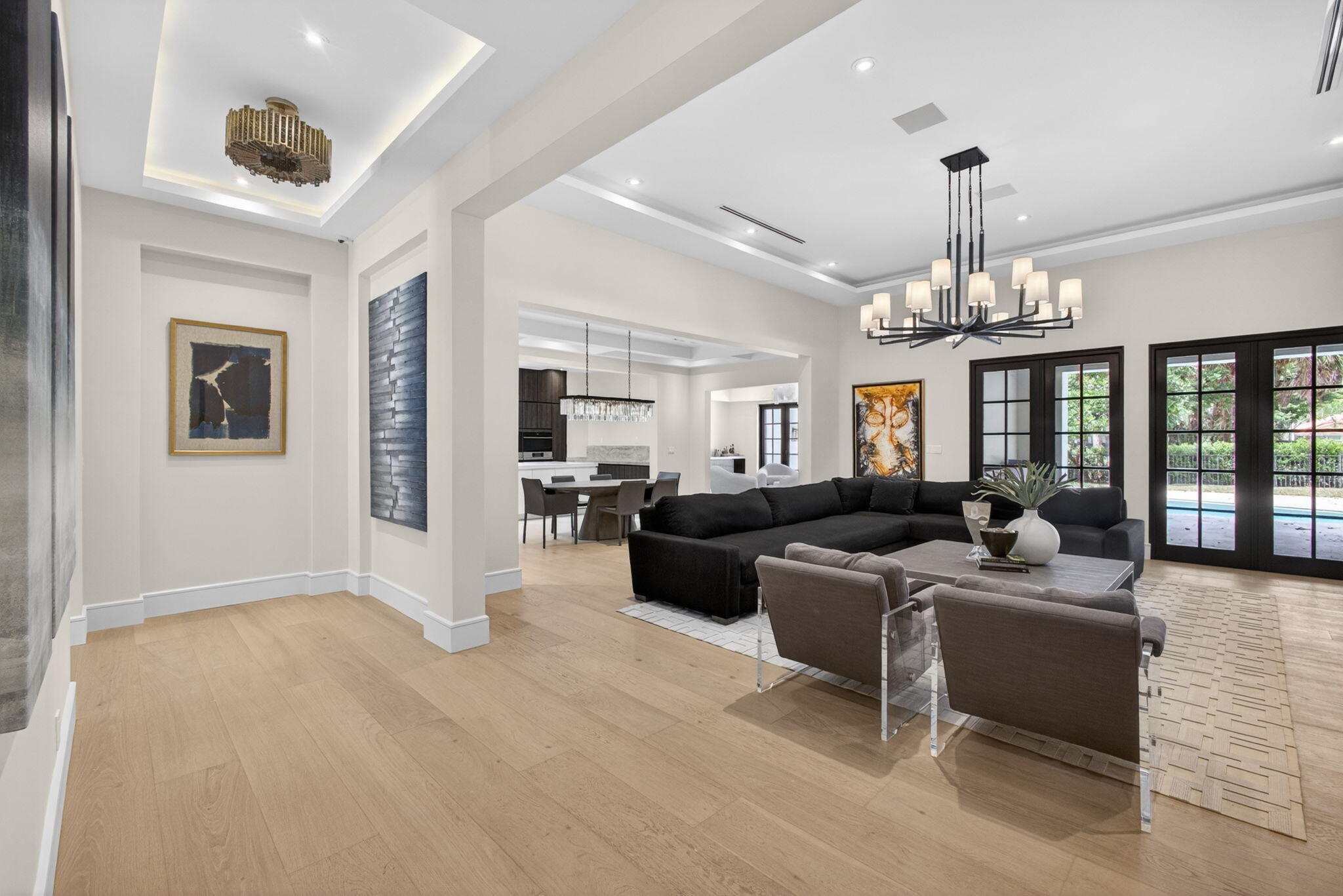17 Carrick Road Palm Beach Gardens, FL 33418 - Photo 5 of 53 a living room with furniture a chandelier a fireplace and a chandelier
