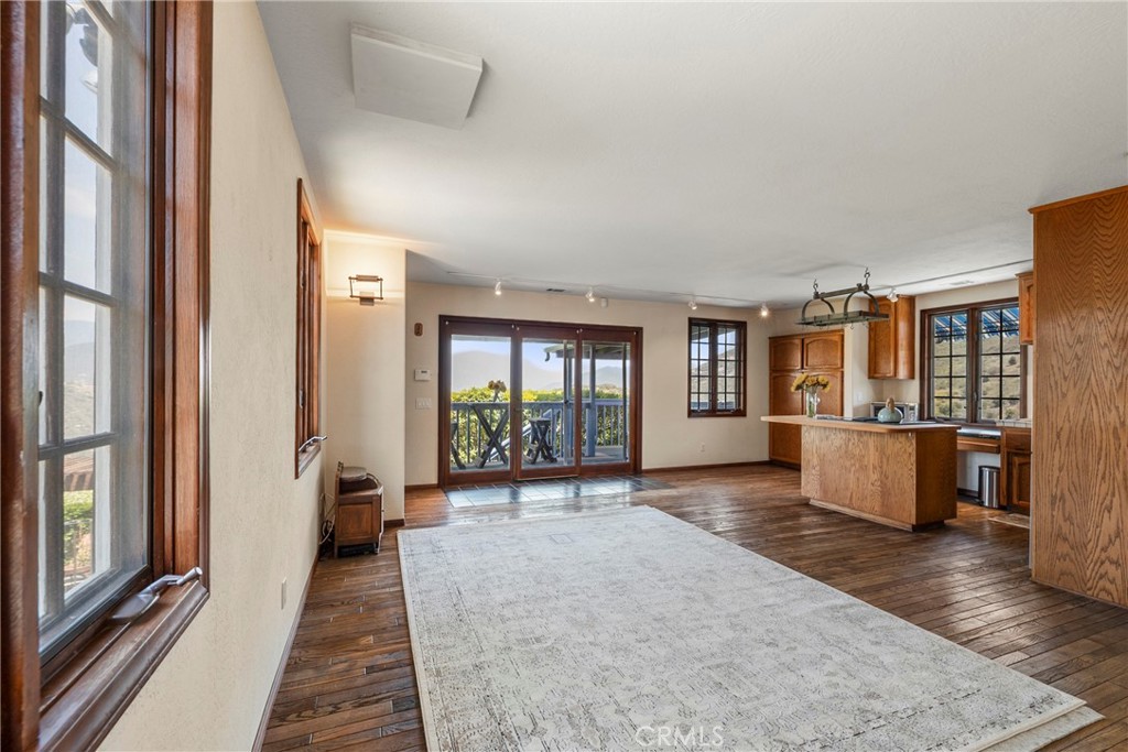 335 Rainbow Crest Road Fallbrook, CA 92028 - Photo 11 of 24 a view of a big room with wooden floor and windows