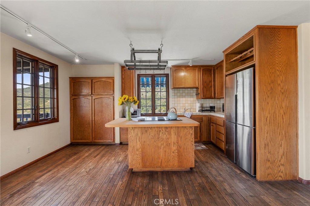 335 Rainbow Crest Road Fallbrook, CA 92028 - Photo 13 of 24 a kitchen with kitchen island wooden floors and stainless steel appliances