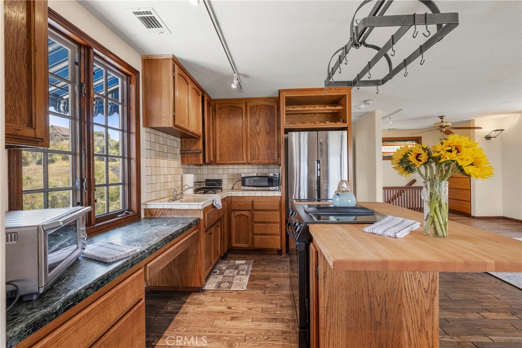 335 Rainbow Crest Road Fallbrook, CA 92028 - Photo 14 of 24 a kitchen with stainless steel appliances granite countertop a sink a stove and refrigerator