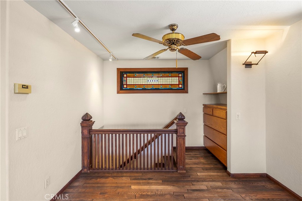 335 Rainbow Crest Road Fallbrook, CA 92028 - Photo 16 of 24 a view of a hallway with wooden floor and staircase