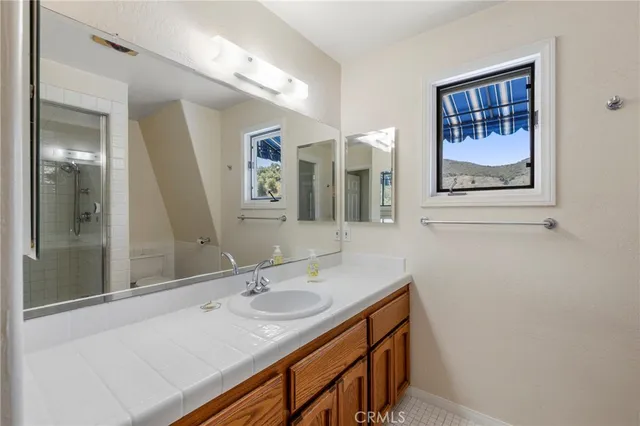 a bathroom with a sink double vanity and a mirror