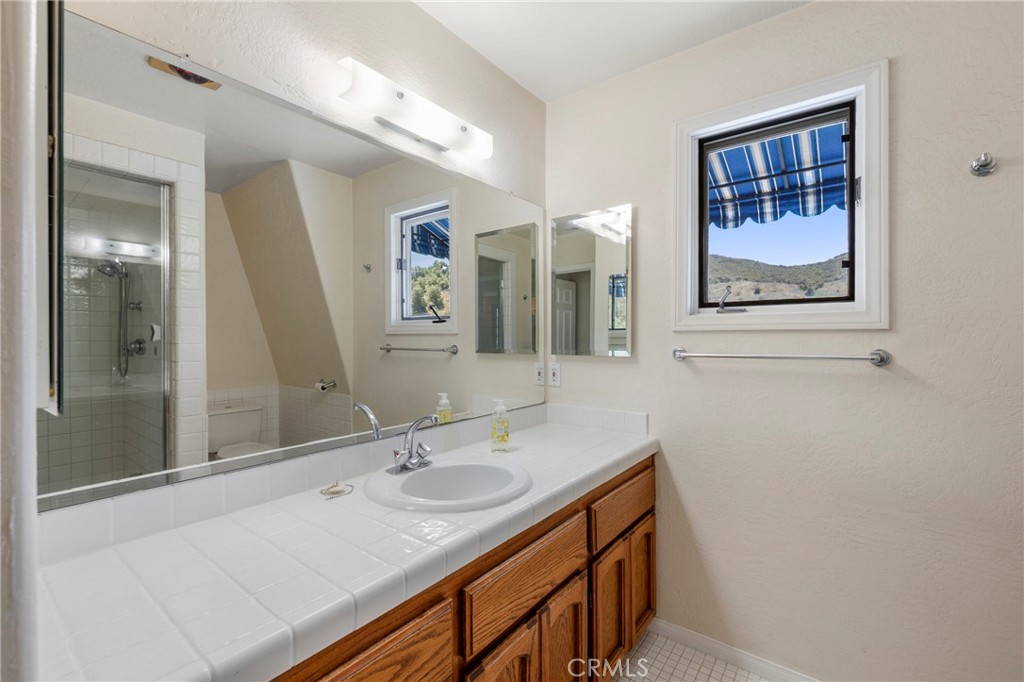 335 Rainbow Crest Road Fallbrook, CA 92028 - Photo 18 of 24 a bathroom with a sink double vanity and a mirror