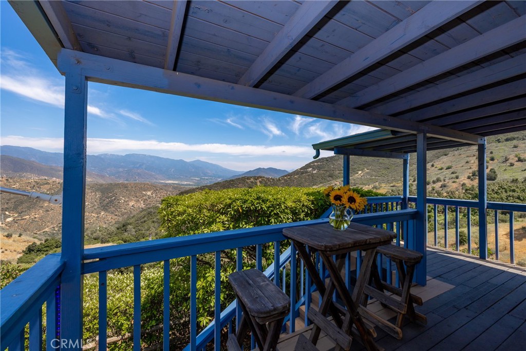335 Rainbow Crest Road Fallbrook, CA 92028 - Photo 4 of 24 a view of a balcony with furniture and wooden floor