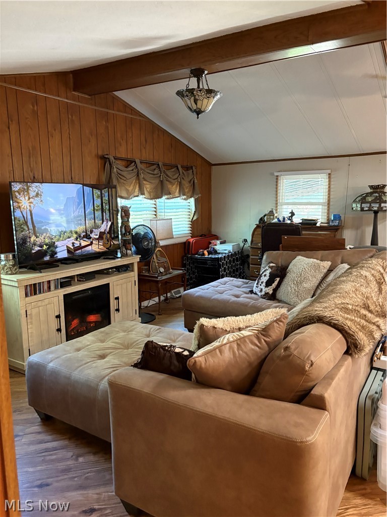 8701 Mayfield Road, Unit 148 Chesterland, OH 44026 - Photo 6 of 24 Living area featuring vaulted ceilings with exposed wood beams