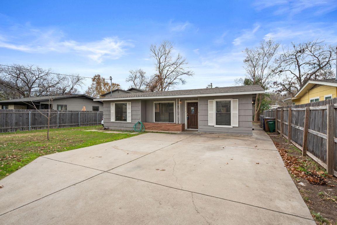 303 Irma Drive, Unit A Austin, TX 78752 - Photo 2 of 35 View of front of home featuring a patio, wide concrete driveway.