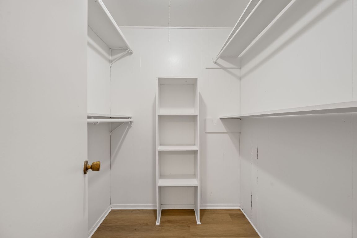 303 Irma Drive, Unit A Austin, TX 78752 - Photo 21 of 35 Walk in closet featuring light wood-type flooring