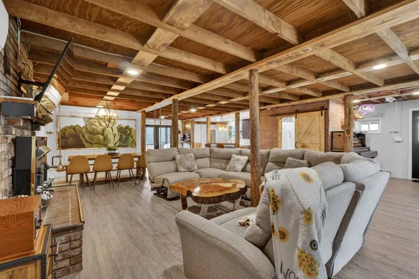 a living room with furniture and a floor to ceiling window