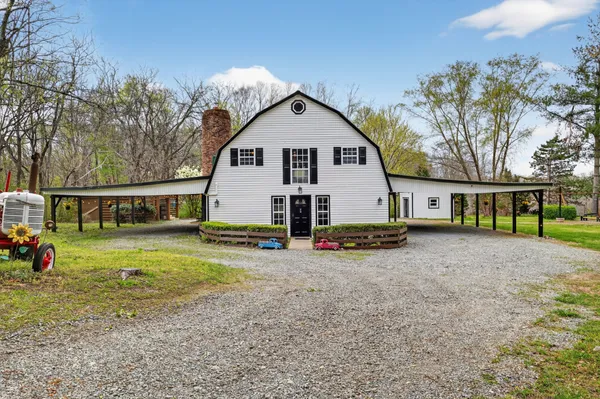 a kitchen with stainless steel appliances granite countertop a sink a stove and a wooden floors