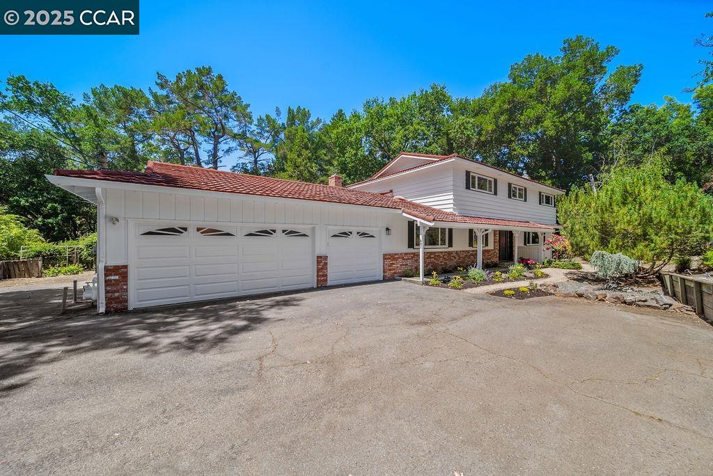 53 Brookside Road Orinda, CA 94563 - Photo 1 of 1 a front view of a house with a yard and garage