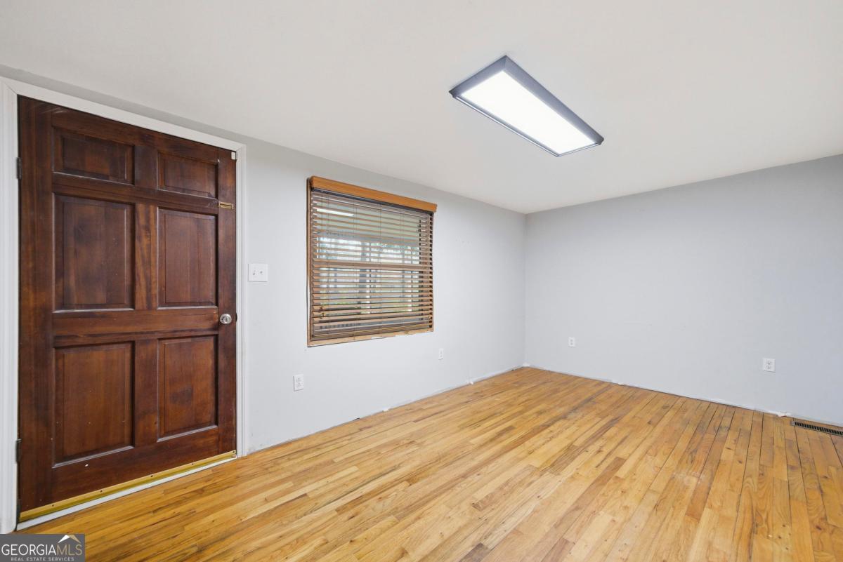 296 Kings Road Milledgeville, GA 31061 - Photo 12 of 36 a view of empty room with wooden floor and fan