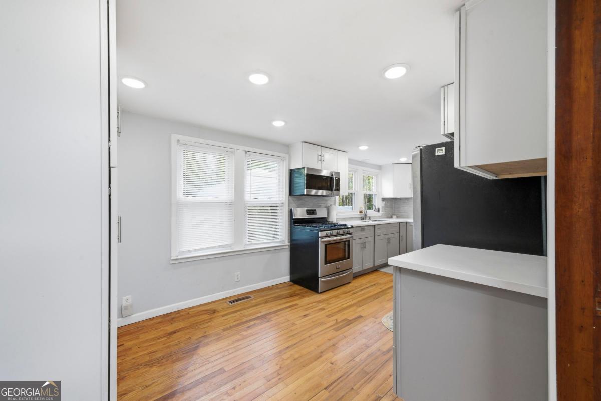296 Kings Road Milledgeville, GA 31061 - Photo 13 of 36 a kitchen with a refrigerator and a stove top oven