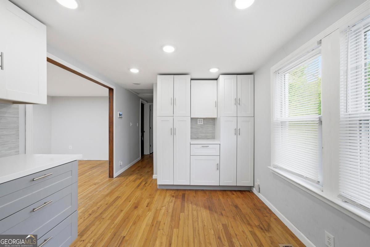 296 Kings Road Milledgeville, GA 31061 - Photo 18 of 36 a view of an empty room with wooden floor and a window