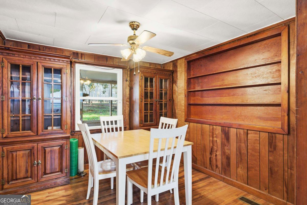 296 Kings Road Milledgeville, GA 31061 - Photo 19 of 36 a view of a dining room with furniture window and wooden floor