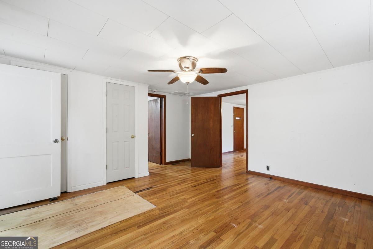 296 Kings Road Milledgeville, GA 31061 - Photo 23 of 36 a view of an empty room with window and wooden floor